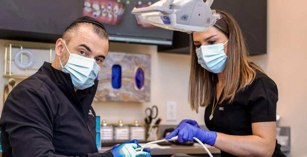 Dentist and assistant treating a patient