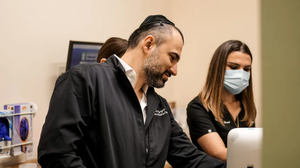 Dentist and assistant reviewing a patient case