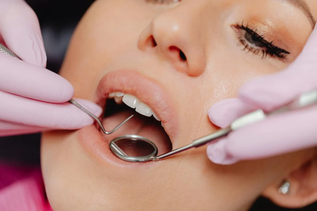 Dentist examining a patient with a mirror and probe
